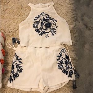 White two piece with blue embroidering
